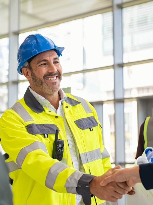 mature-architect-and-contractor-shaking-hands-at-construction-site.jpg